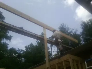 Carpenter setting a ridge beam over a new addition frame — Ice Dam Removal by Roofing Brothers in River Forest
