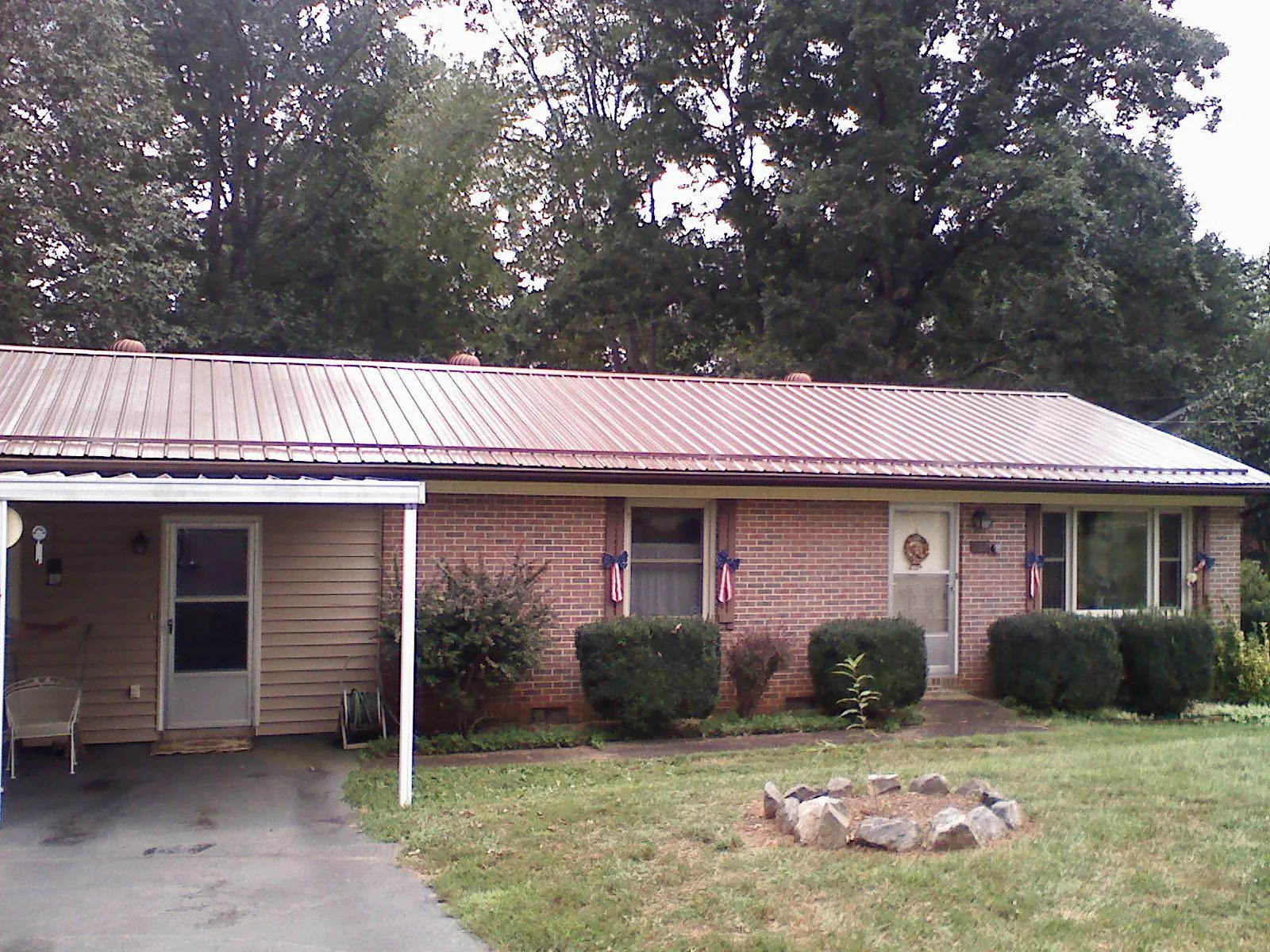 Bronze metal roof and carport on a brick ranch home — Roof Repair work by our crew in River Forest